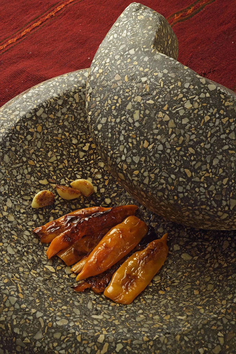 red peppers chilis on batan pestle and mortar