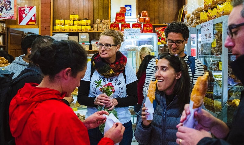 curious monkey food tours in cusco people eating churros