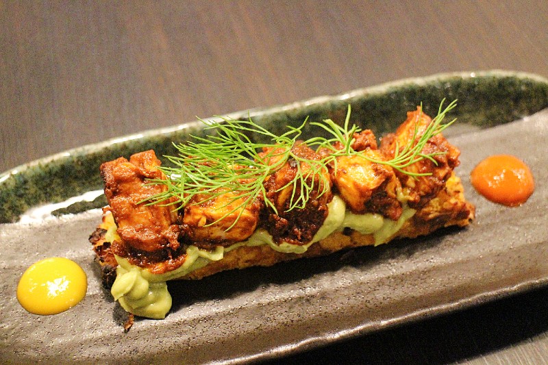 pulpo with corn grain cake organic nikkei dish. Japanese Peruvian Cuisine example