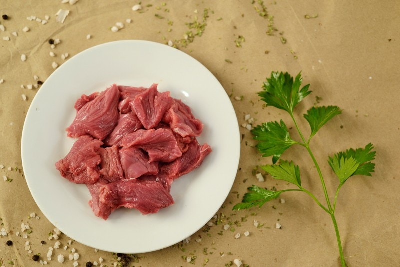Raw strips of sirloin steak