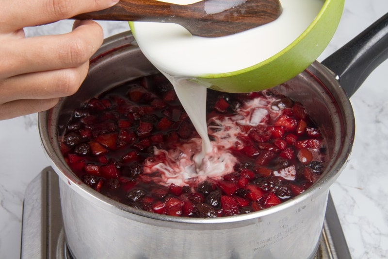 add flour and water to chopped fruits in pot