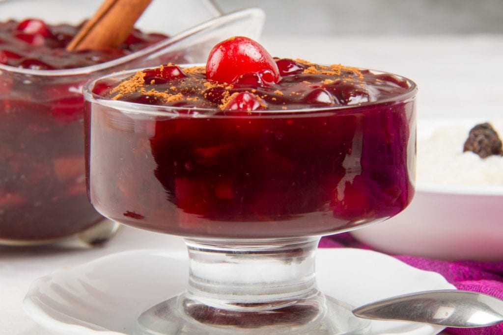 close up of mazamorra morada dessert in glass bowl