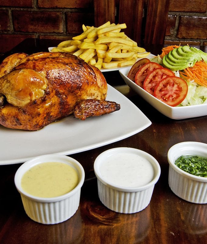 Pollo a la Brasa with salad and dipping sauces