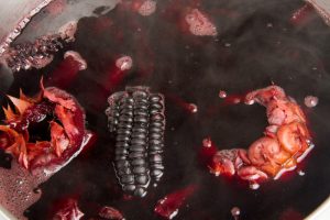purple corn and pineapple boiling in pot
