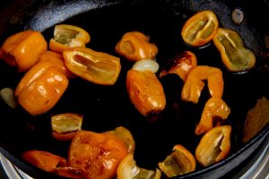 Frying yellow peppers in pan