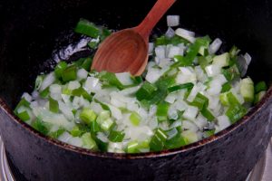 add onion and chives to oil in pot