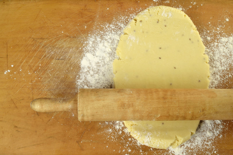flatten the alfajor dough with a bread roller
