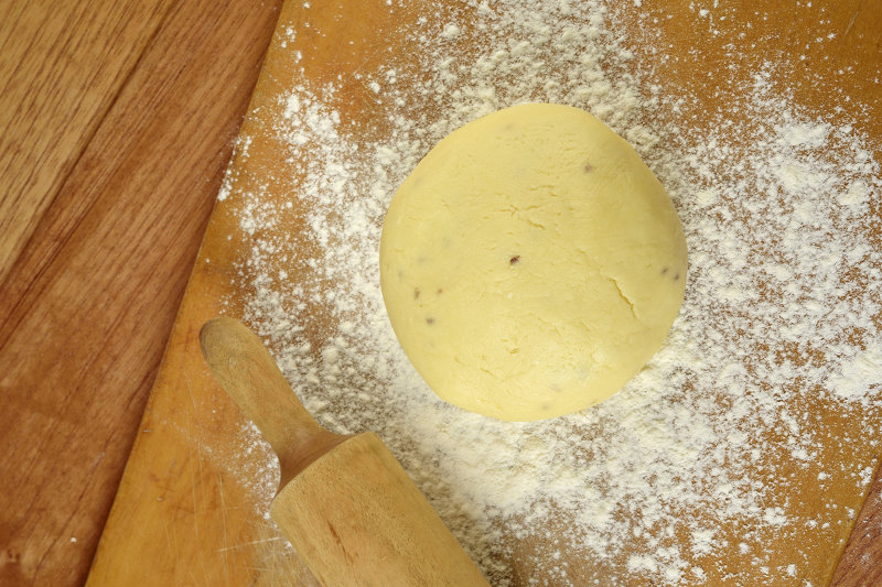 flatten the alfajor dough with a bread roller