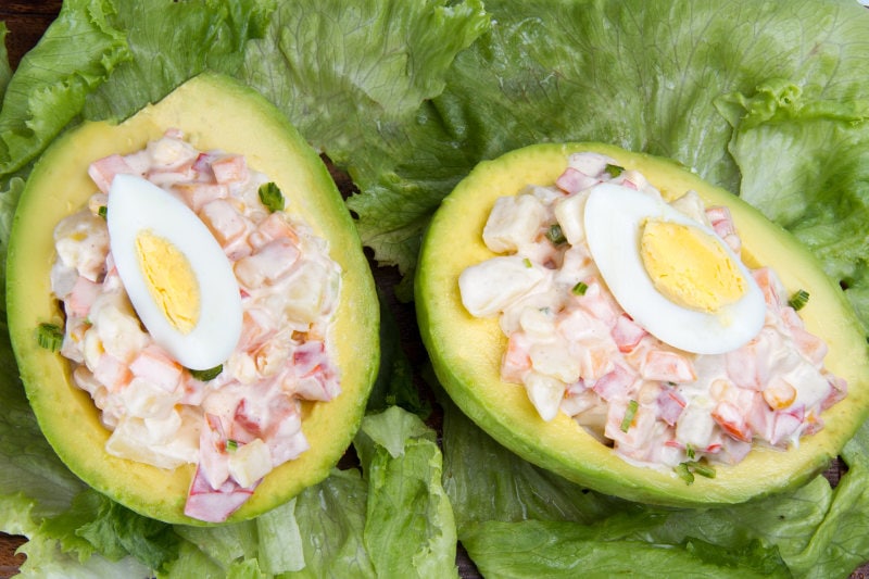place avocado halves on a bed of lettuce