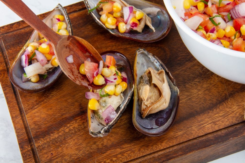 close up of mussel with corn onion and culantro