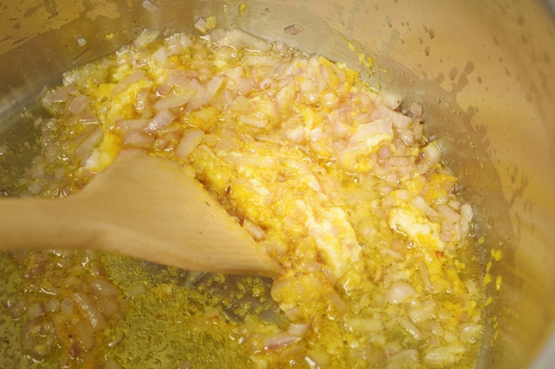 Fry aji panca paste with garlic