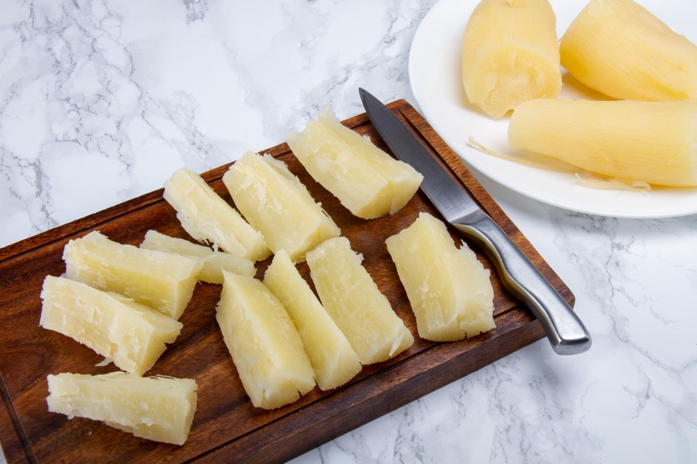 Sliced Pieces Of Yuca On Chopping Board With Knife