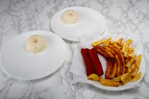 Arrange The Potatoes Rice And Salchicha On Plates