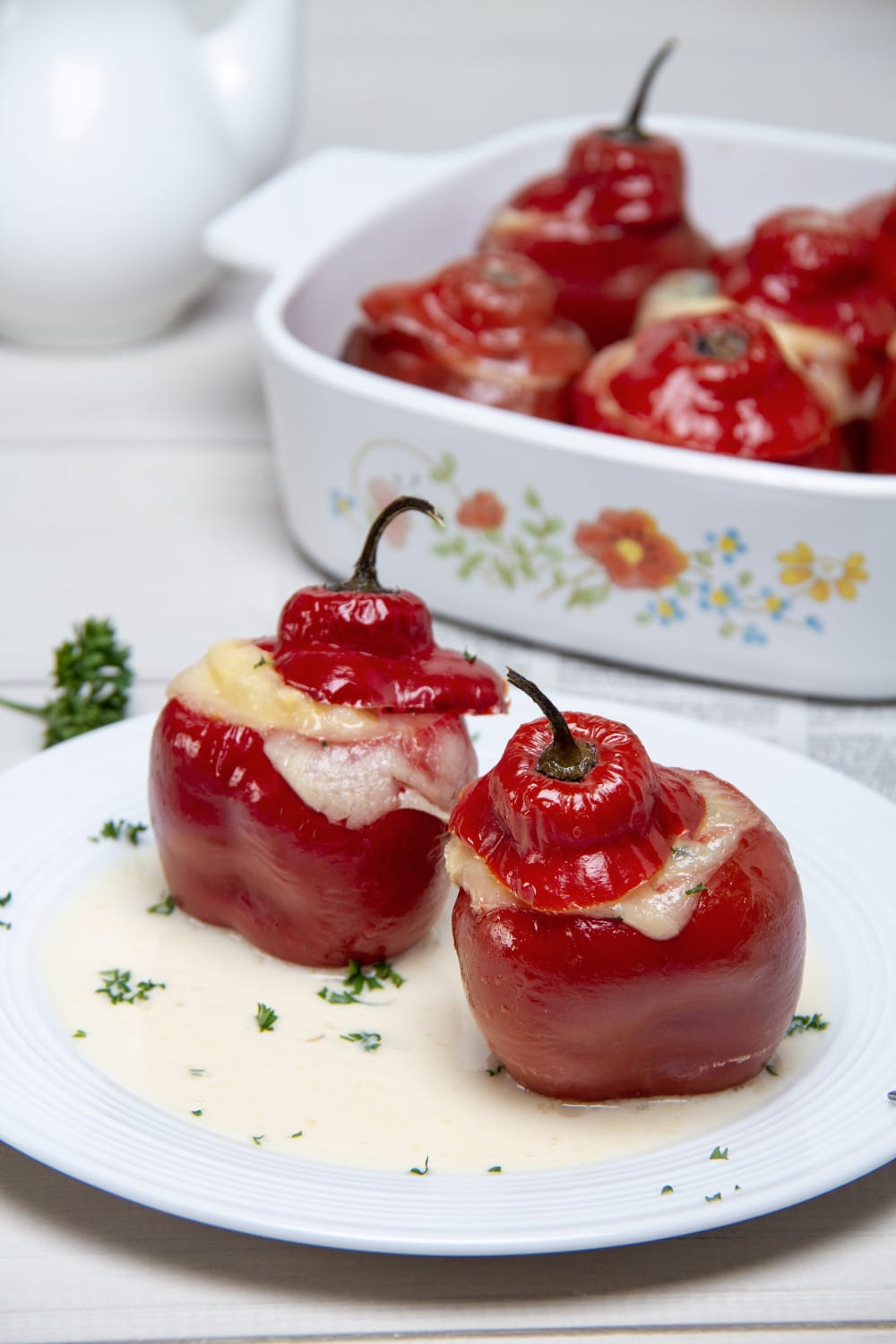 Stuffed Red Peppers On Plate With Evaporated Milk Sauce