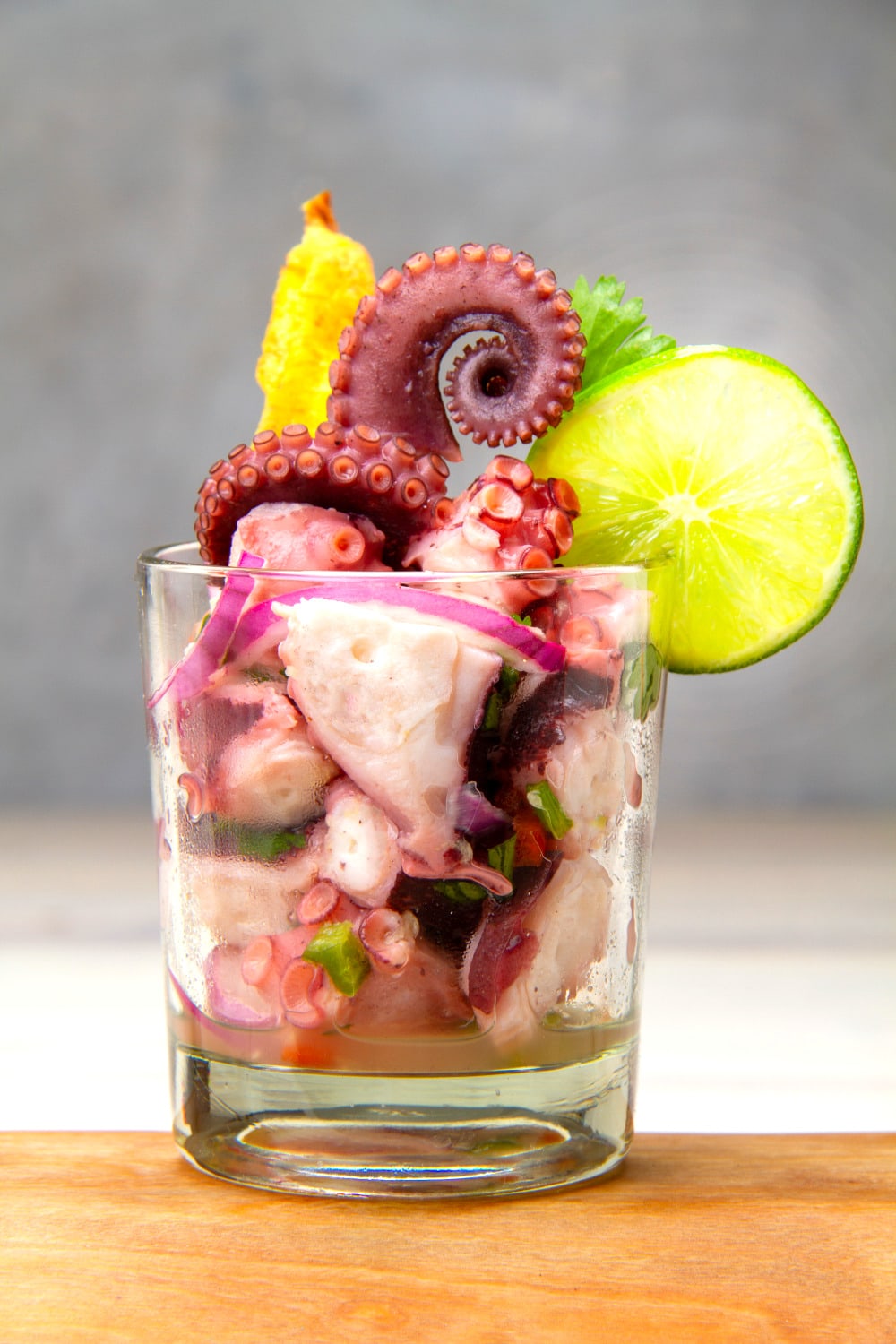 glass of pulpo ceviche with lime and platano