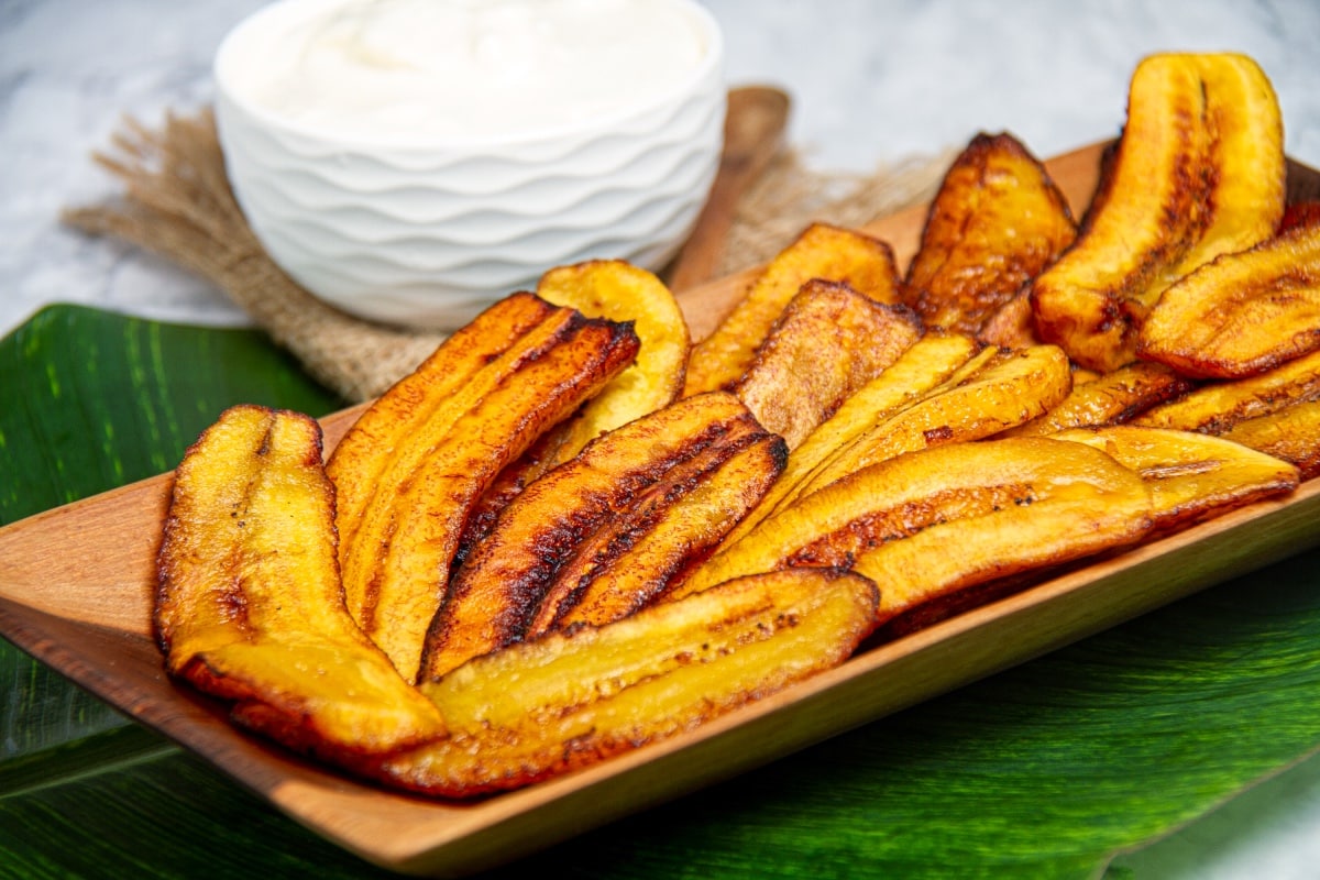 plate of of ripe platanos fritos peruvian dish with dipping sauce