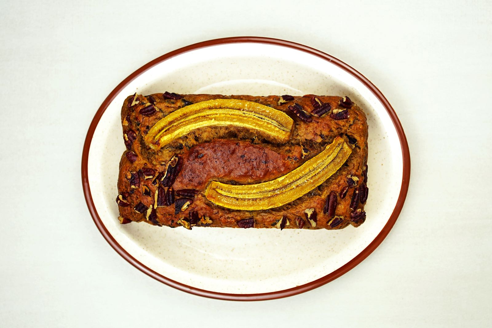 Person serving freshly baked banana bread