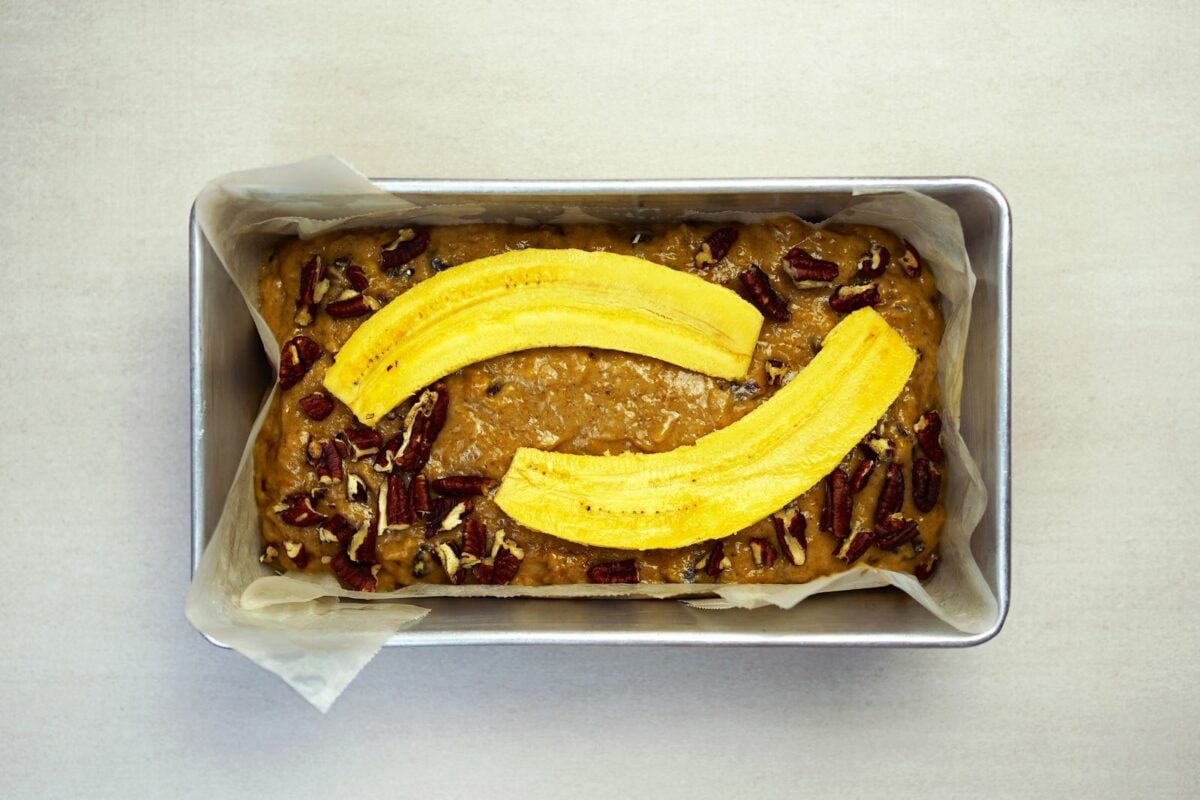 Pouring batter into loaf pan for bread preparation