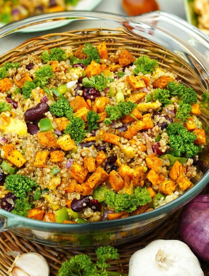 Colorful quinoa vegetable salad in glass bowl.