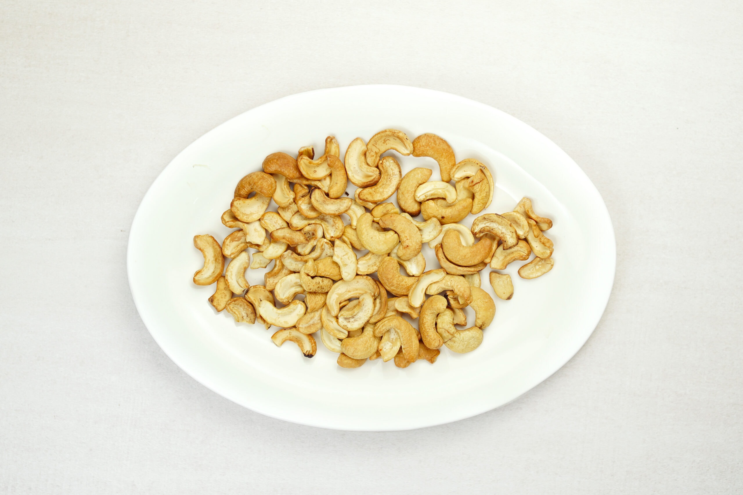 Roasted cashew nuts on white plate