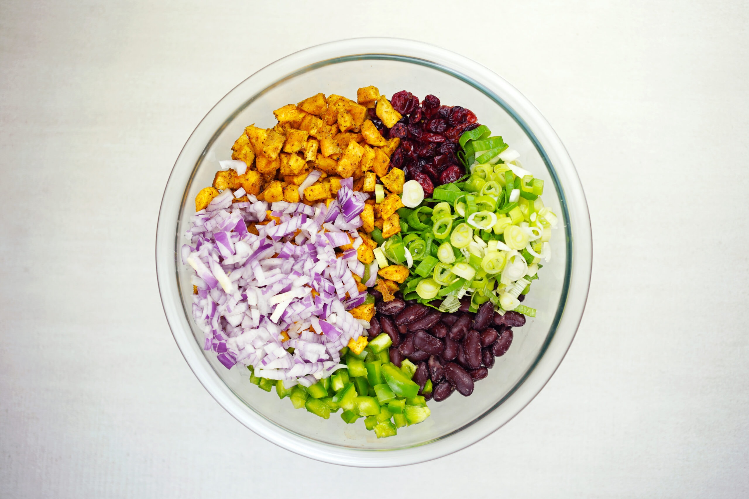 Colorful mixed salad ingredients in bowl.