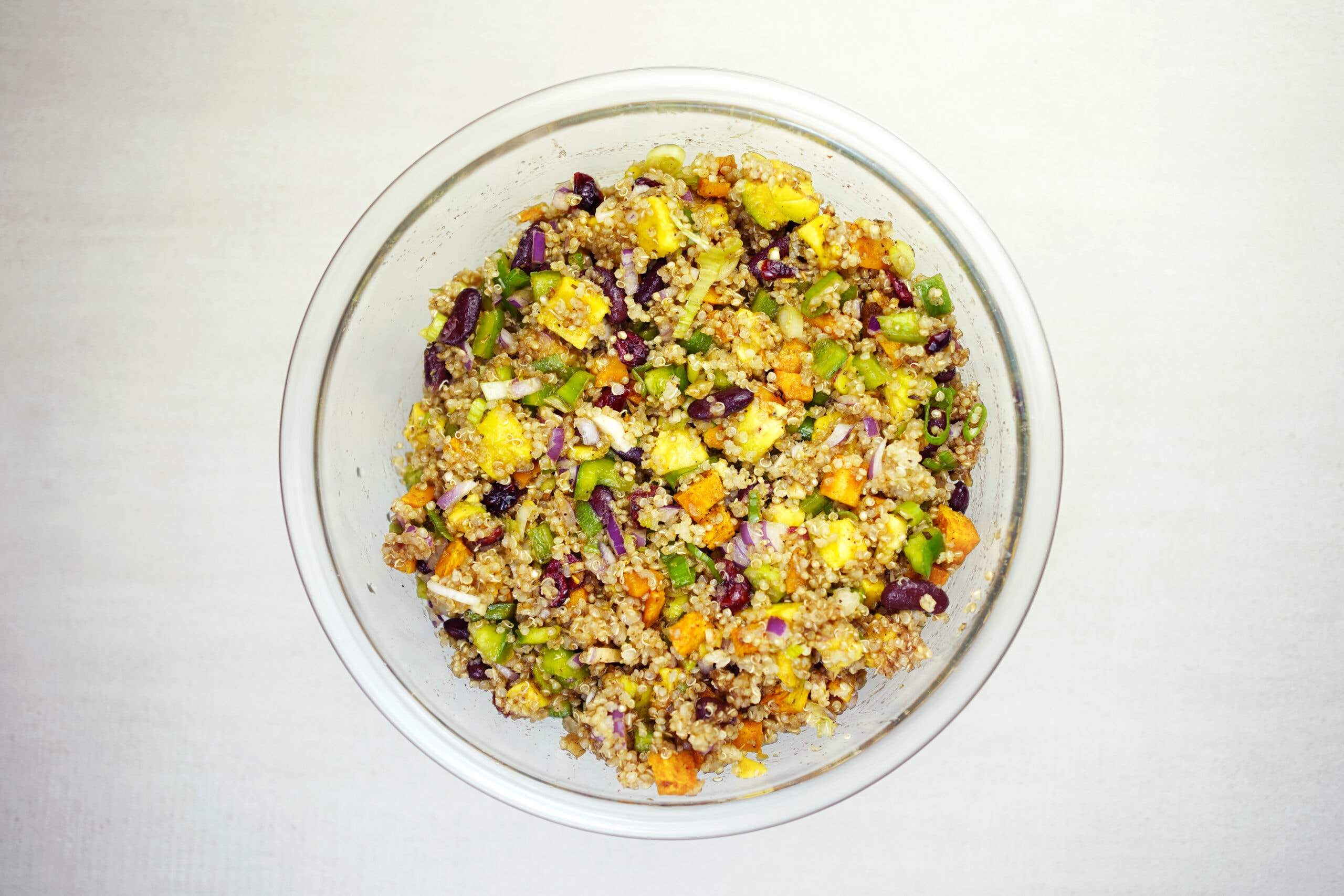 Colorful quinoa vegetable salad in bowl.