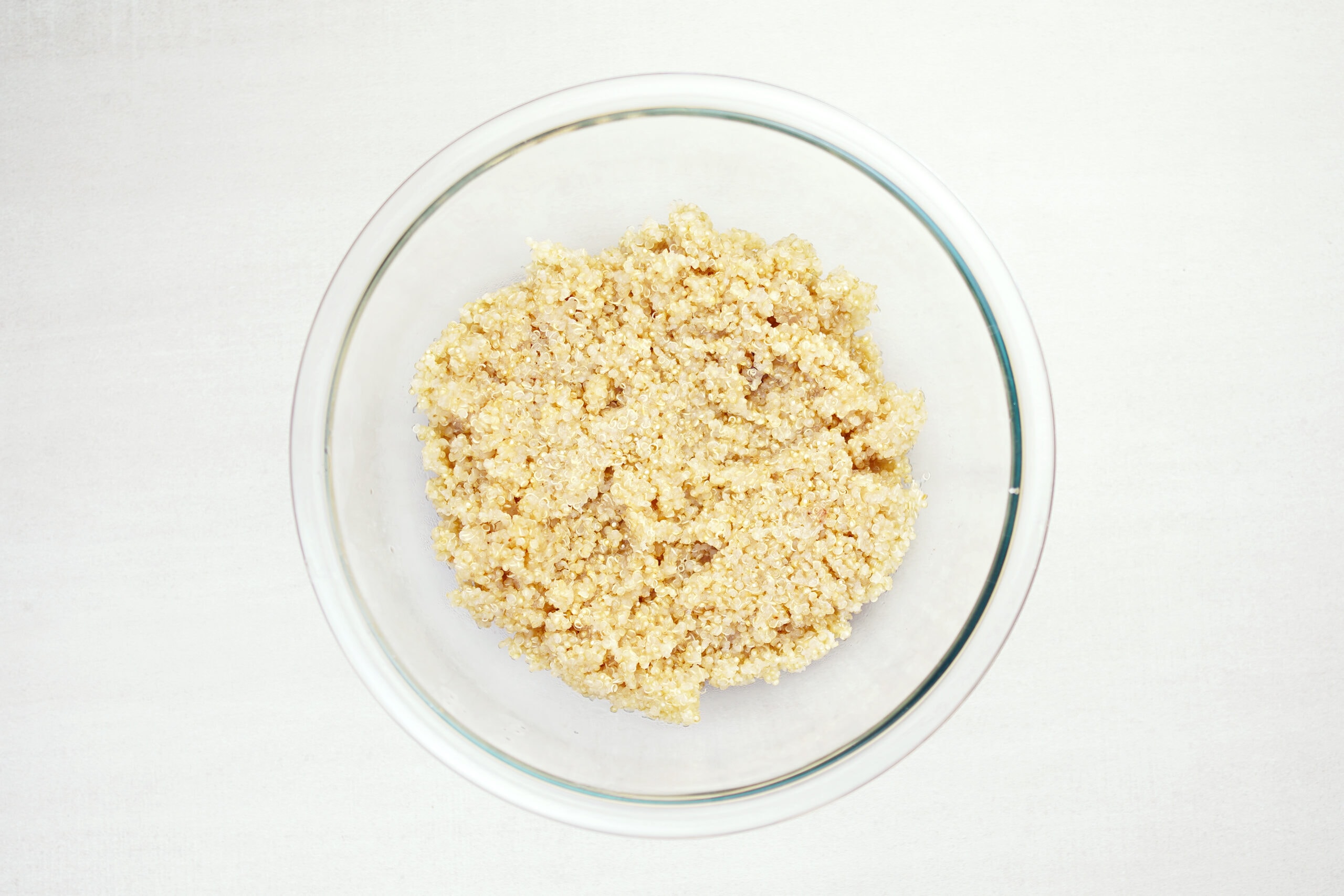Cooked quinoa in a glass bowl.