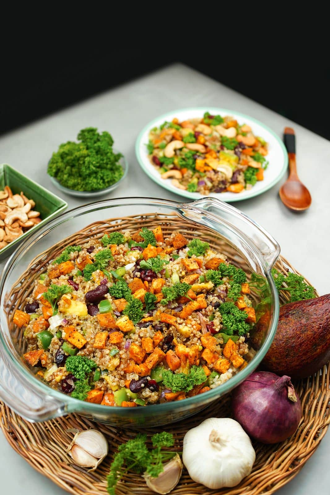 Colorful quinoa vegetable salad in glass bowl.